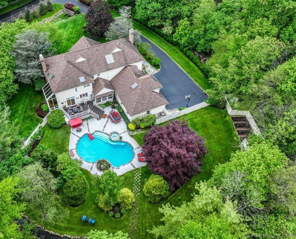 Nestled on a coveted, serene cul de sac in Wilton, this 5 bedroom, 4.