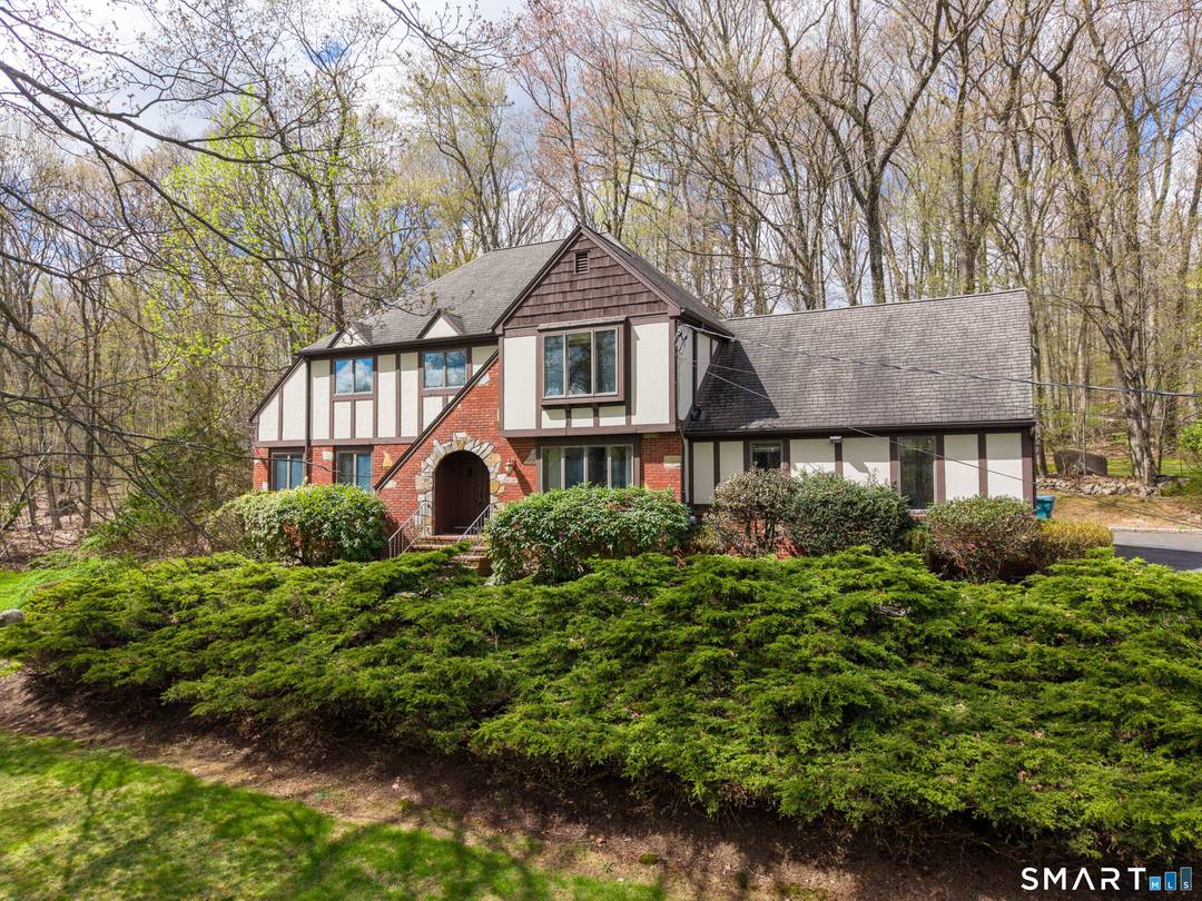 This remarkable Tudor inspired home offers privacy, presence, and a distinctive sense of style.