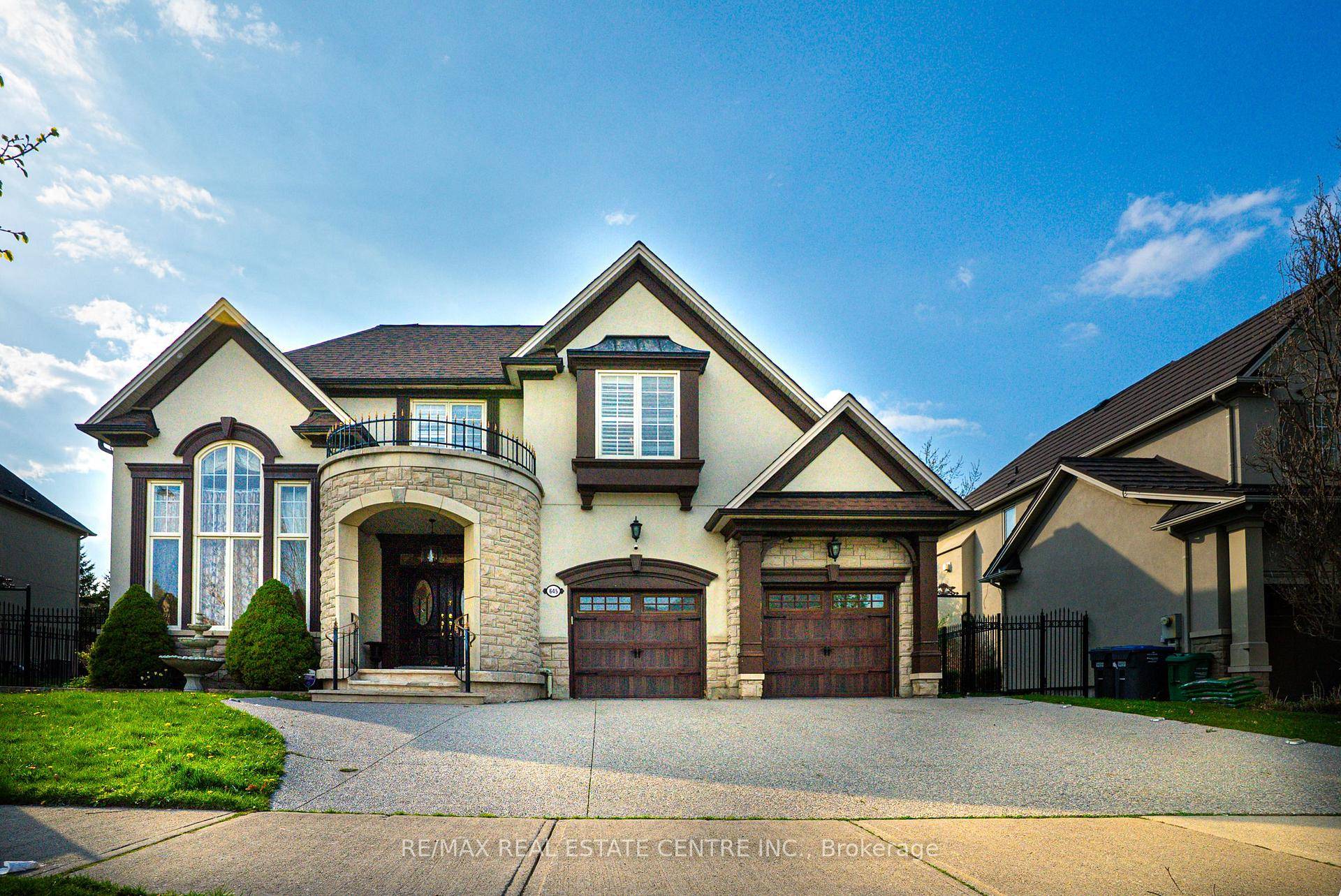 Nestled in a sunlit cul de sac on a wide premium lot, surrounded by iron fence.