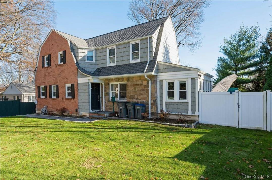Welcome to this beautifully maintained Dutch Colonial situated in a prime White Plains location, featuring three spacious bedrooms, two full bathrooms, and a convenient powder room.