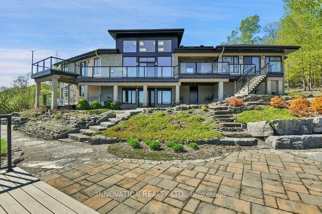 EXCEPTIONAL RIVERFRONT PROPERTY Perched high above the Ottawa River this substantial highly customized home is designed to capture breathtaking views with private river access.