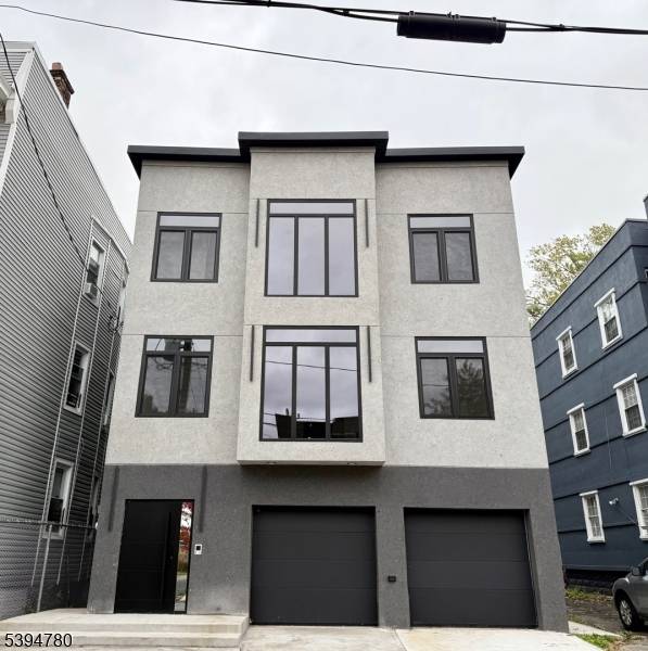 A statement of sophistication and craftsmanship, this custom new construction two family residence redefines modern living in Irvington, NJ.