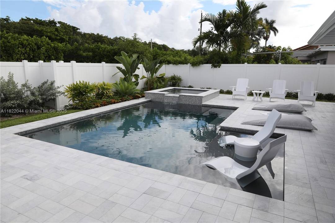 Stunning and spacious 3 2 home in the prestigious Hollywood Lakes area with a spectacular backyard oasis featuring a contemporary pool spa, covered patio with misting system, impeccable landscaping and ...