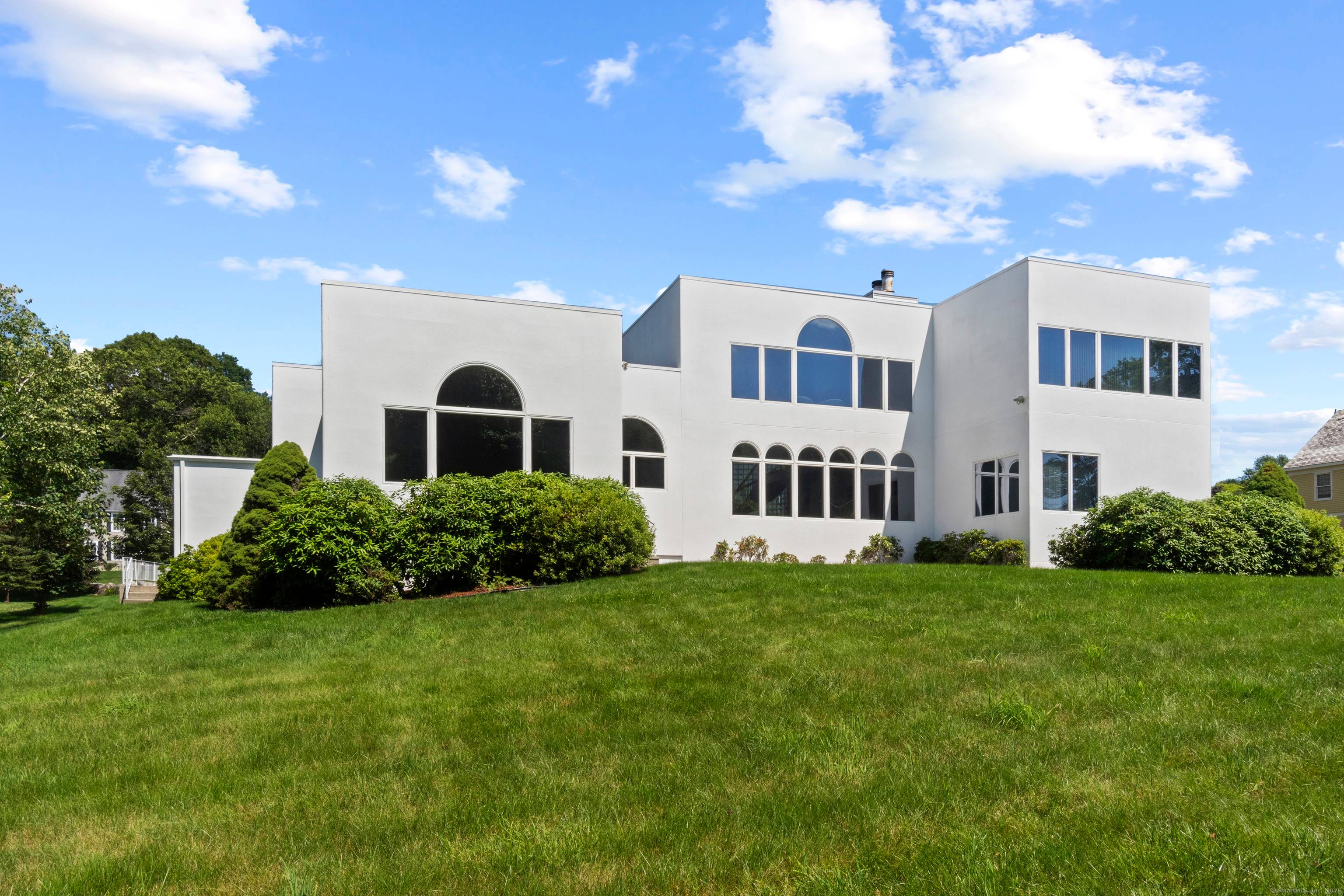 This elegant contemporary home in Noank, CT, offers a seamless blend of luxury and modern design, featuring soaring high ceilings and an expansive open floor plan that creates a sense ...