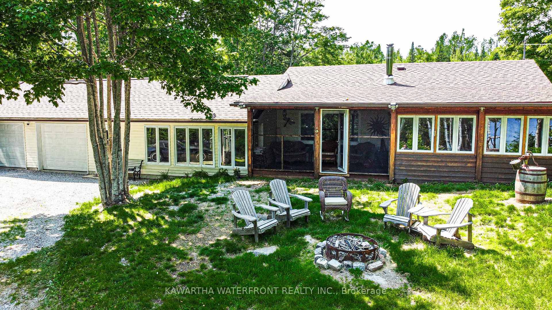 Perched atop a gentle hill, this charming cottage or home offers breathtaking views of the shimmering lake.