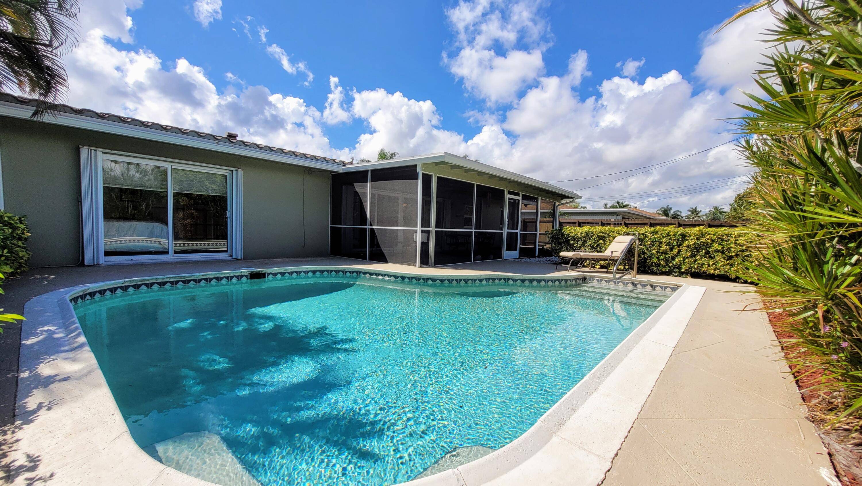 Immaculate East Boca pool home that is walking distance to the new Addison Mizner Elementary Move into a worry free home that has been updated with all impact hurricane windows, ...