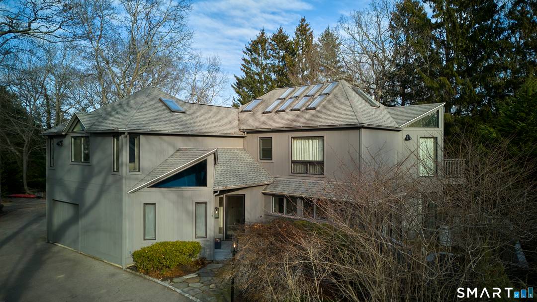 MYSTIC MASONS ISLAND. Located within the Private Association on beautiful Masons Island, this spacious light and bright Contemporary home is beautifully sited on a private elevated lot.