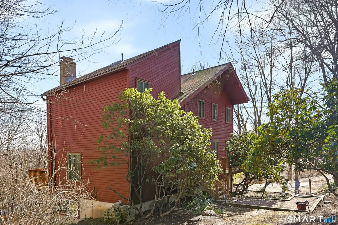 Nestled on a private, wooded setting in desirable Bethel, this distinctive contemporary offers space, character, and versatility across multiple levels.