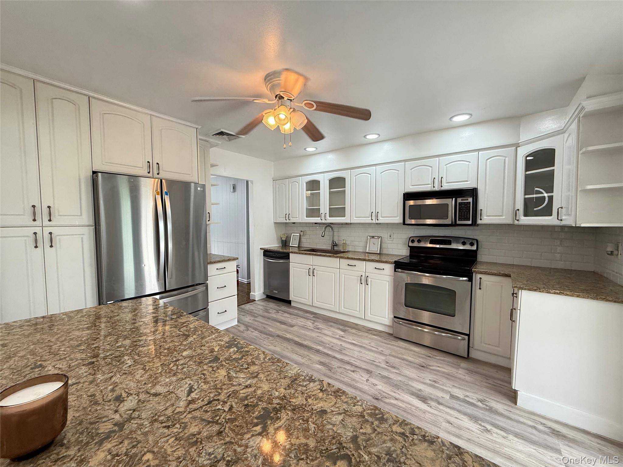 Totally renovated 4 Br, 2 bathroom, Wide line High Ranch, offering the ultimate entertaining space.