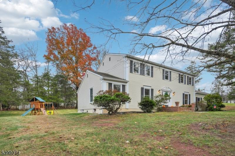 A stately center hall colonial set gracefully on just over an acre, offering the feeling of a private retreat the moment you arrive up the long setback driveway.