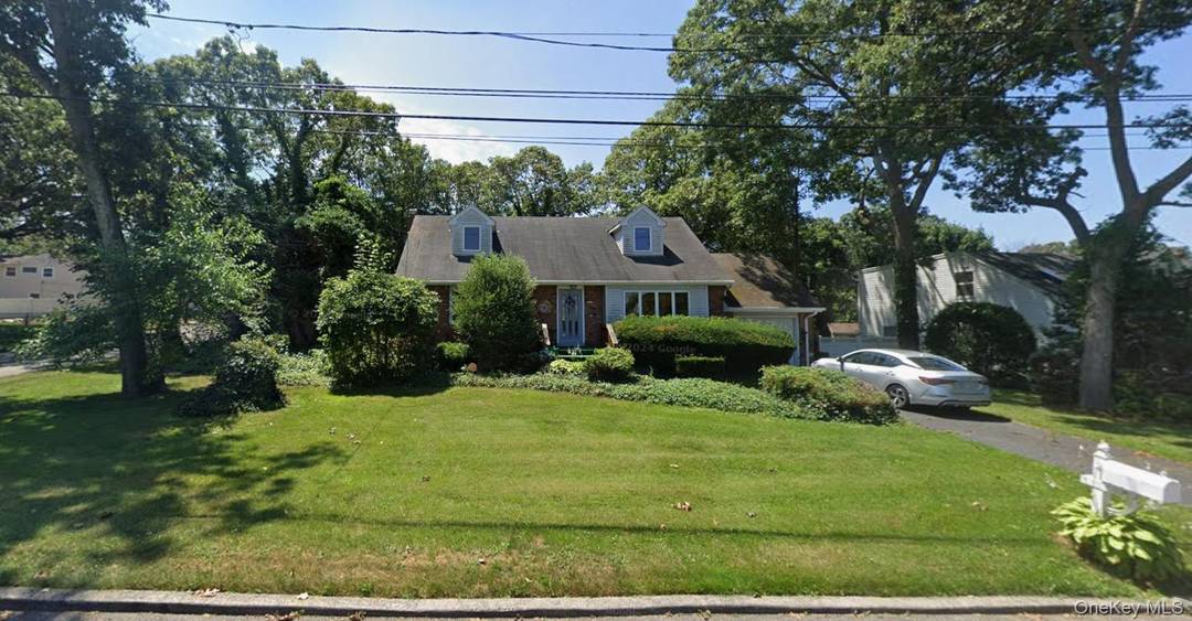 Spacious 4 bedroom, 1 bath corner property featuring a full basement, garage, bocce court, and brand new decking.