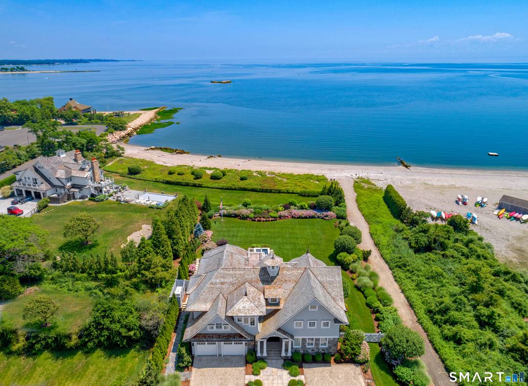 Perched at the point of Saugatuck Island, Seven Sandpiper Road is pure New England perfection.