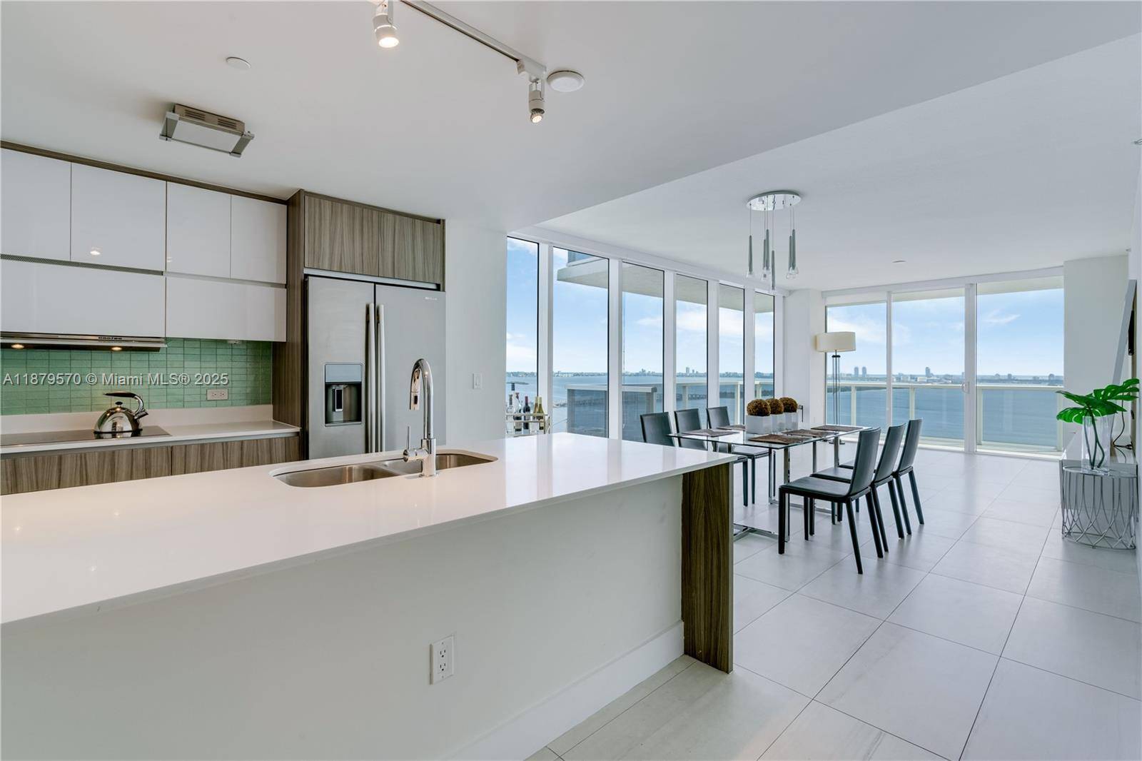 Experience luxury living with breathtaking views of Biscayne Bay from this stunning 3 bedroom, 2.
