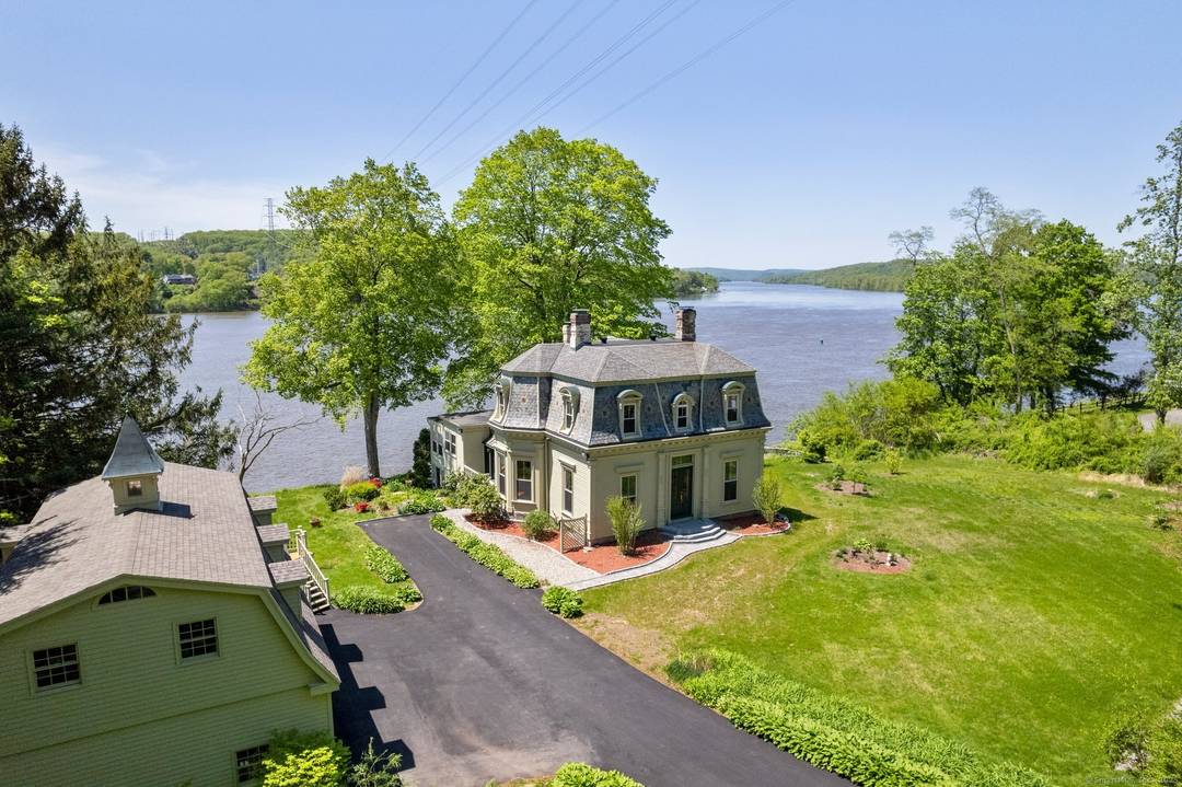 The striking David Watrous house, located on the CT river, offers unobstructed views of the river where it merges with the Salmon river from every room.