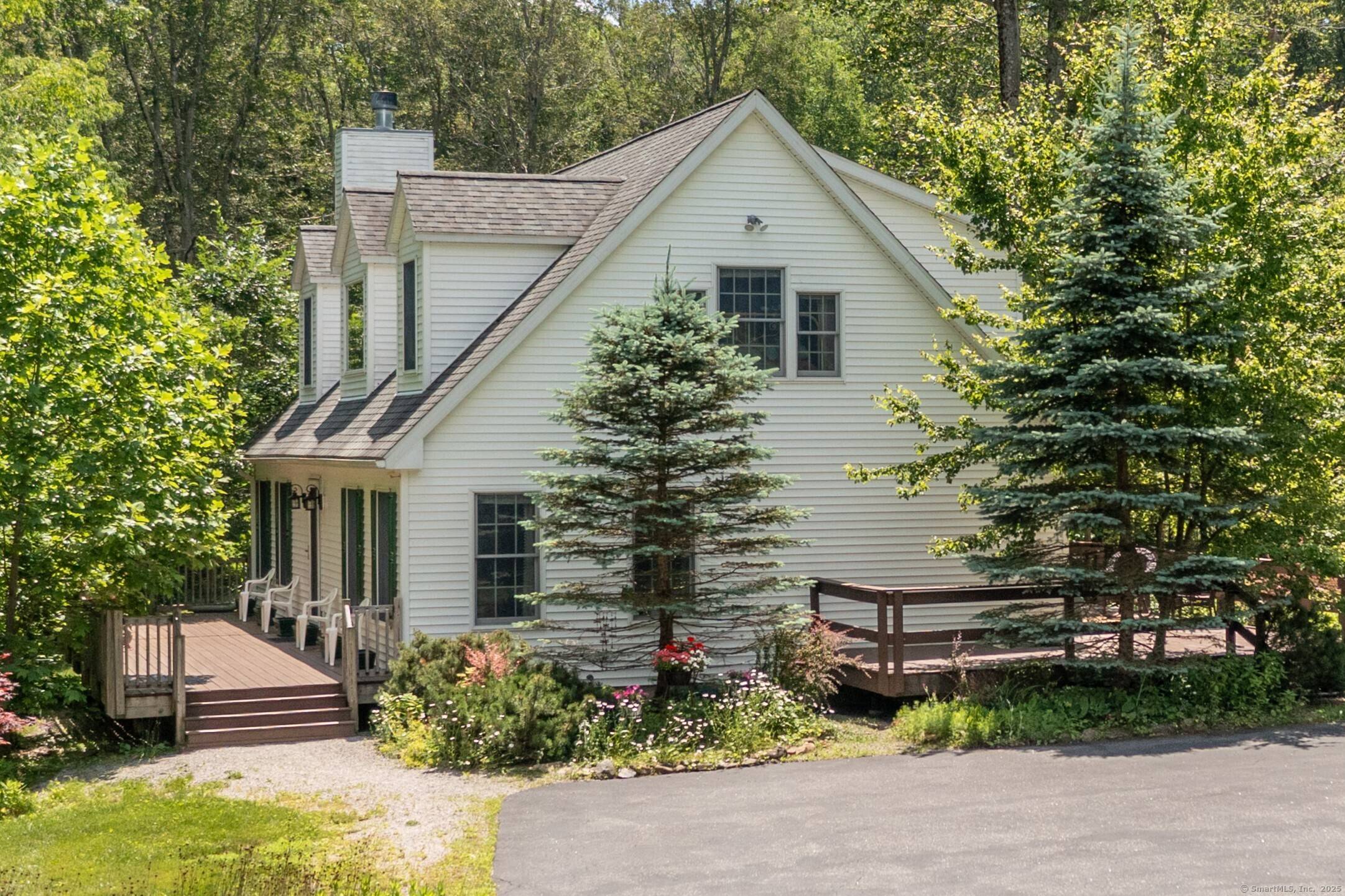 Set on a stunning, open lot with fields, wildflowers, stone walls, and a babbling brook, this oversized Cape offers the perfect blend of cozy living and scenic surroundings.