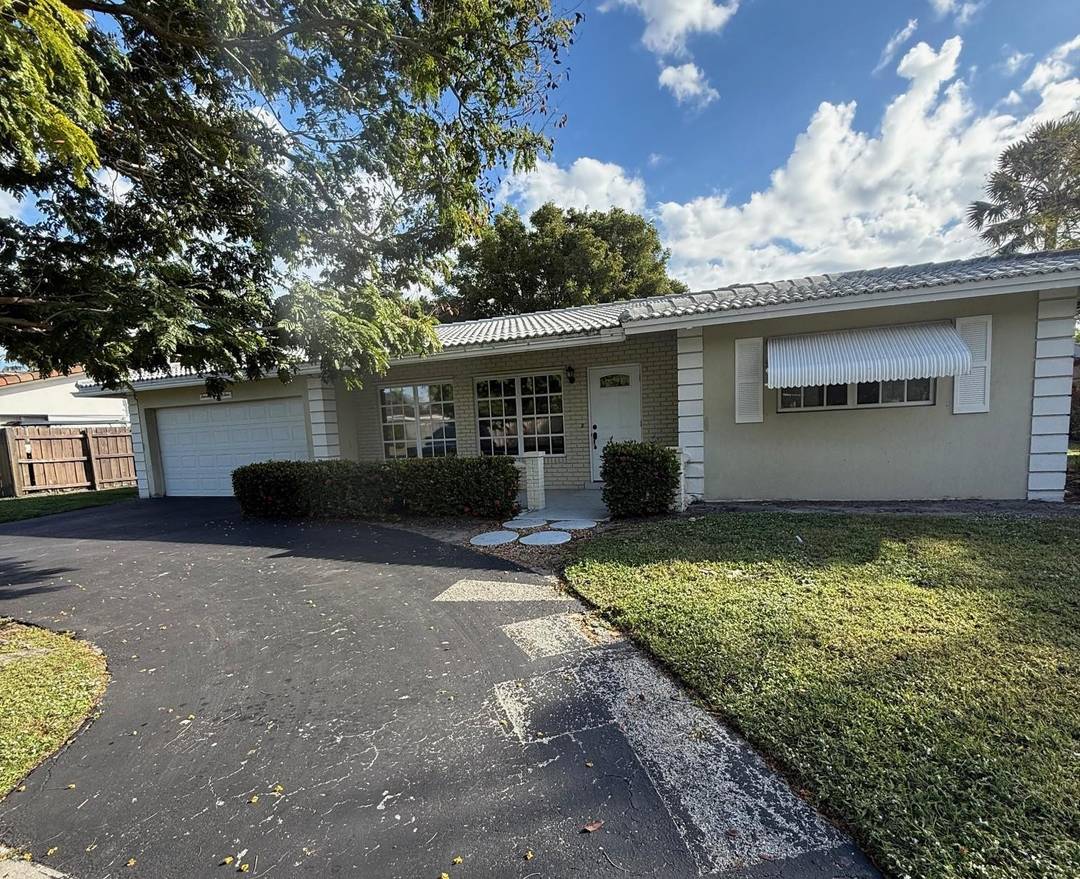 East of Federal Highway, close to beach Just painted Three bedroom two bath with two car garage on corner lot with newer kitchen cabinets and granite countertop and large family ...