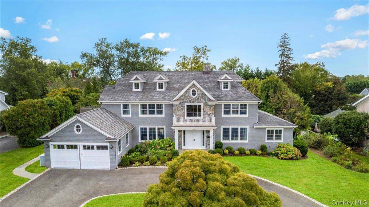 Just steps from a private sandy beach in Orienta Point, this elegant custom built Colonial offers over 8, 300 of useable square footage across four levels, a beautifully landscaped 0.