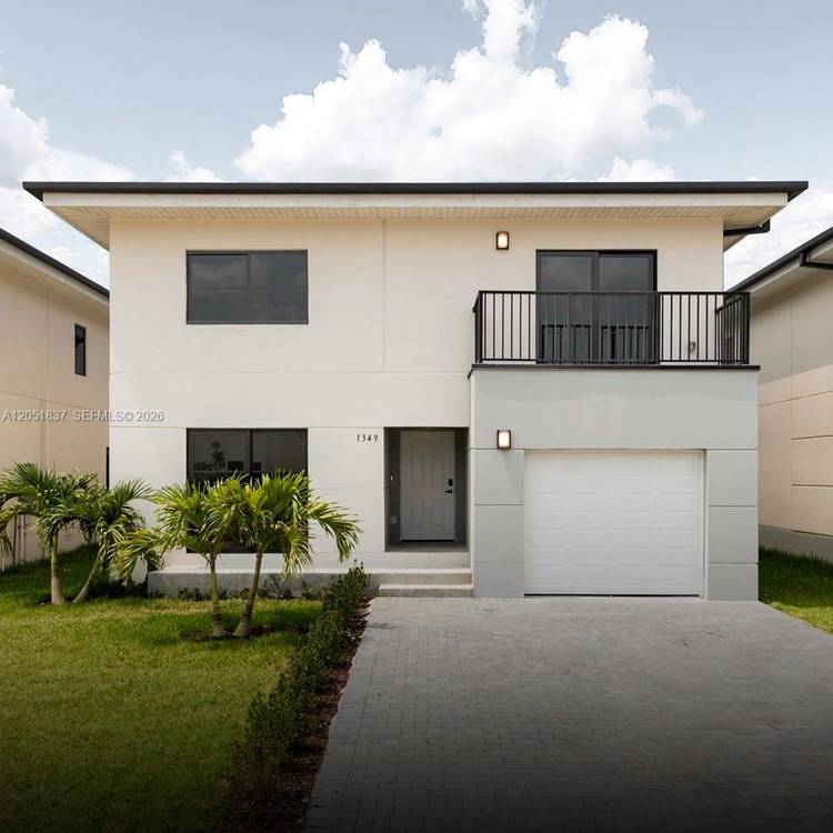 Beautiful concrete construction home featuring porcelain tile floors, impact windows, and a functional layout.