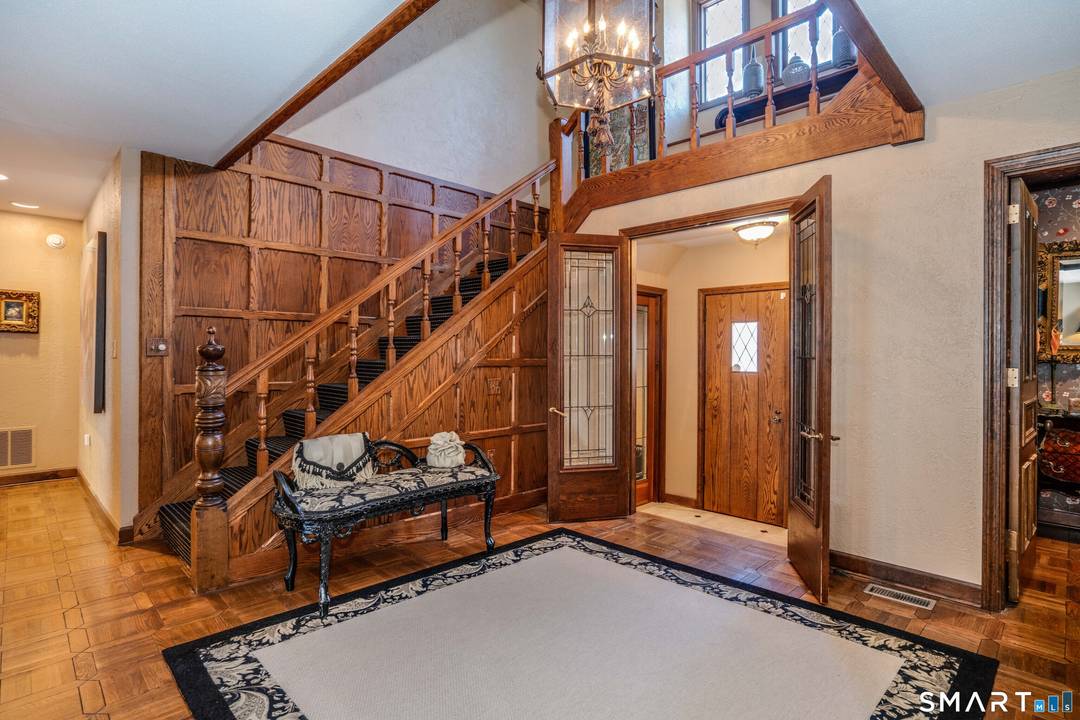 Designed in Tudor style by noted architect Harold Caufield, this outstanding 13 room brick and stone home is a residence of exceptional distinction.