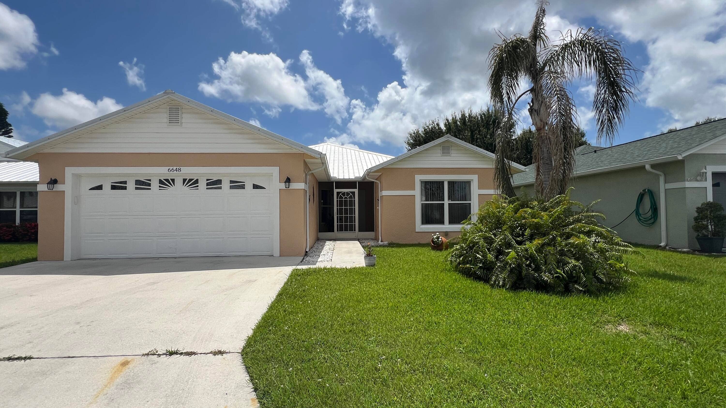 This beautifully upgraded concrete block CBS home features 3 spacious bedrooms, 2 bathrooms, and a 2 car garage, in a 55 community on leased land.