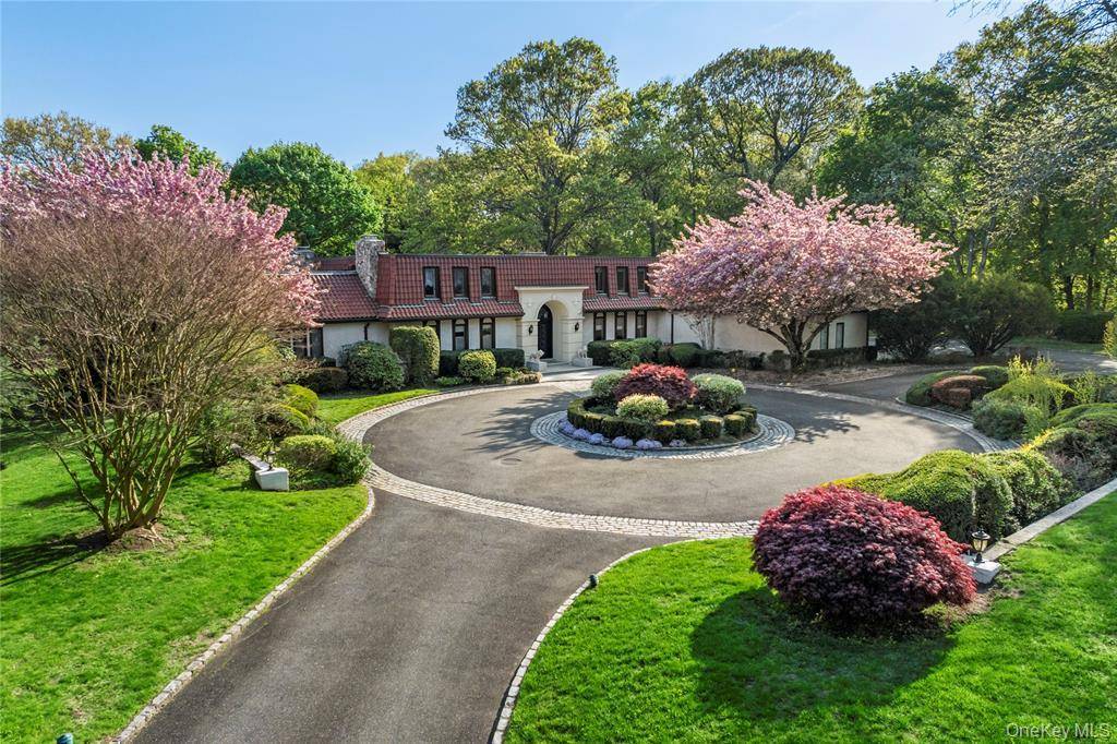 Set on over 2 acres of beautifully landscaped grounds, this elegant Mediterranean style estate offers luxury living in the heart of Old Westbury.