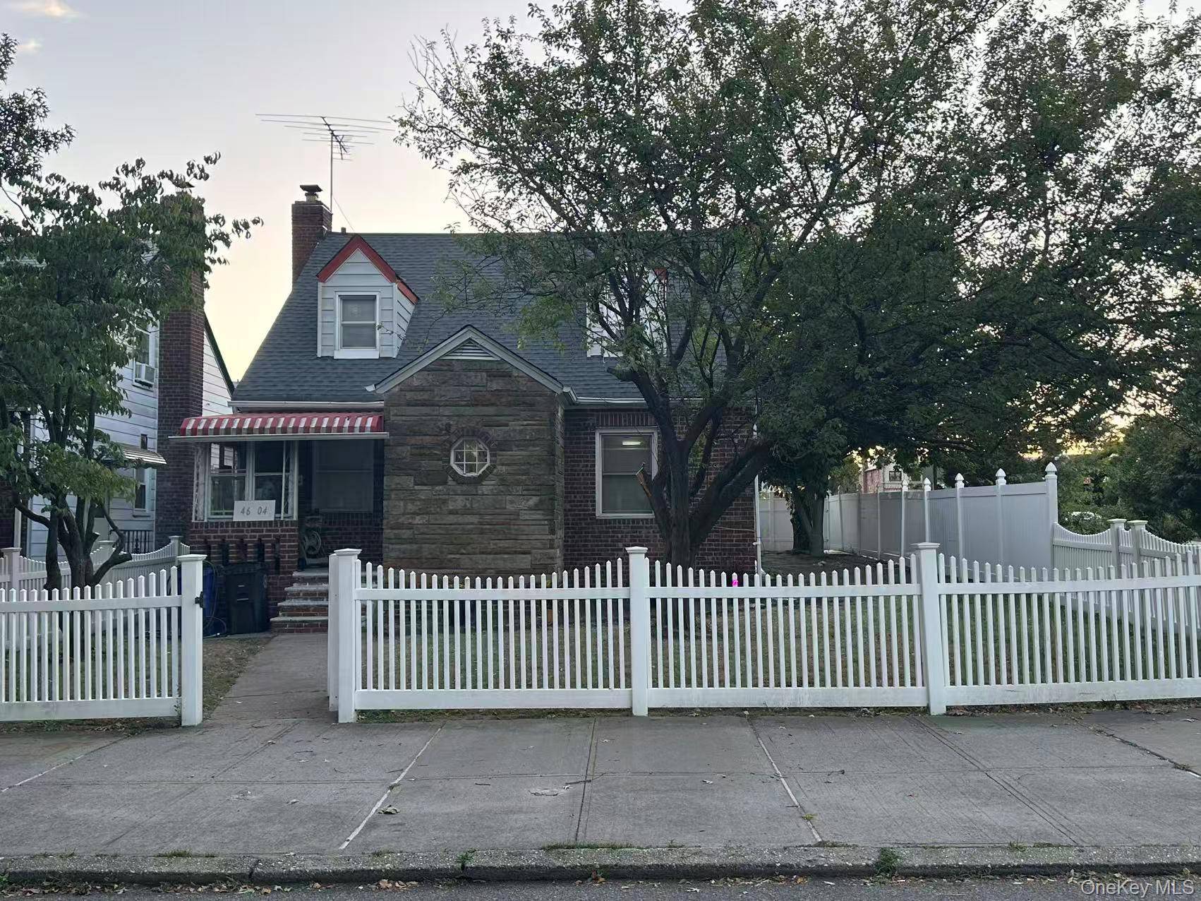 Charming Cape Cod style single family home located on a fenced corner lot in the heart of Flushing.