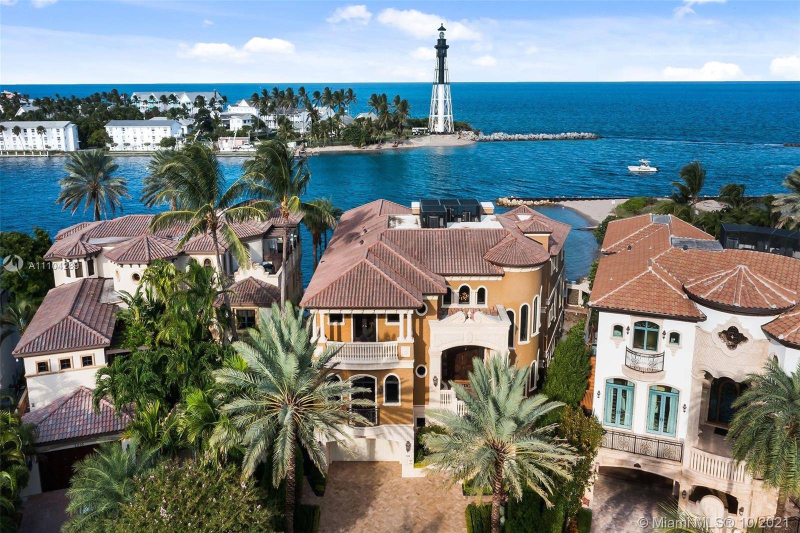 Positioned directly on the Hillsboro Inlet, this unrivaled oceanfront estate encompasses 127' feet of private beach and deep water dockage for multiple yachts.