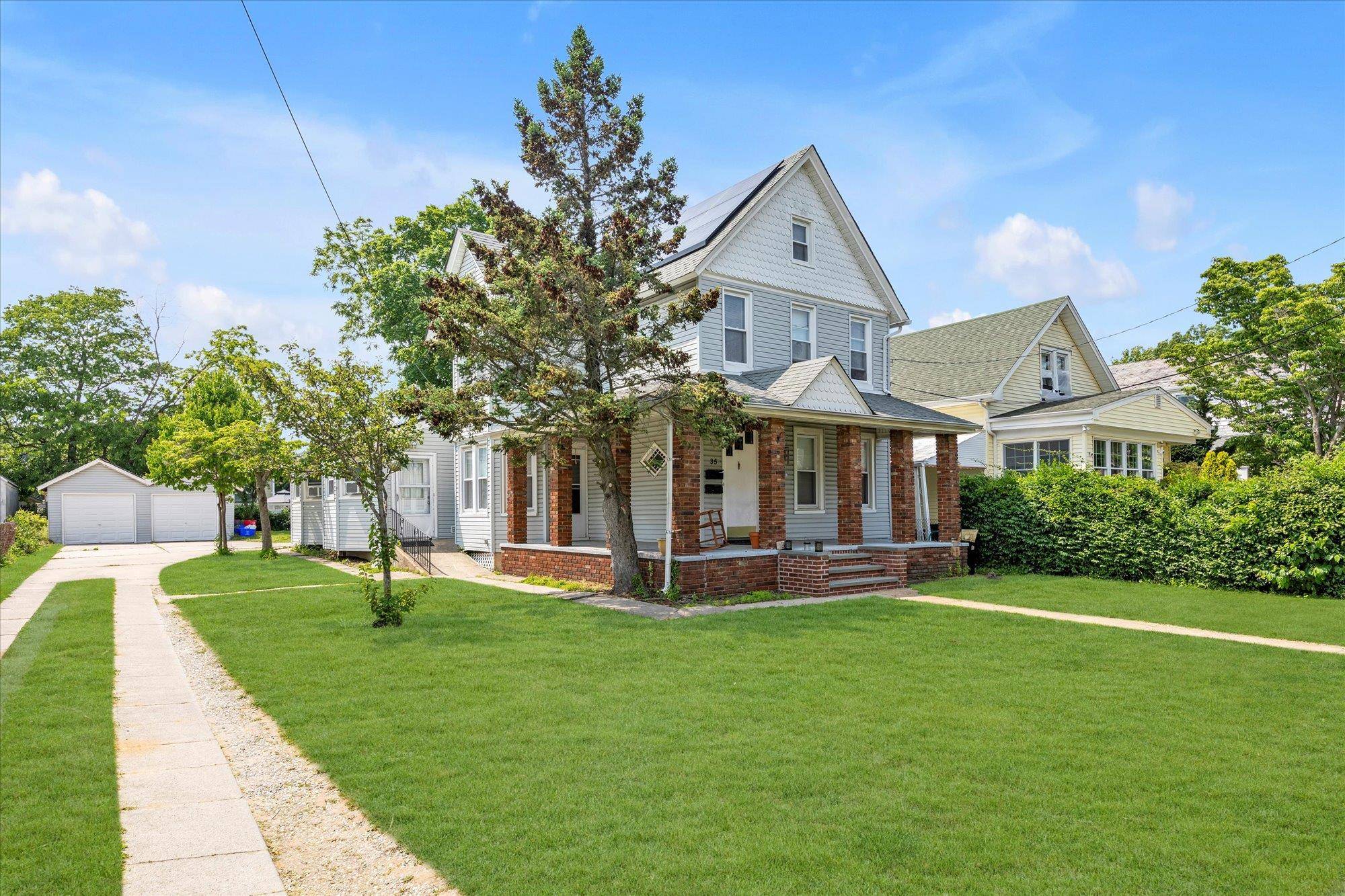 This is a charming two family home on a leafy, oversized lot.