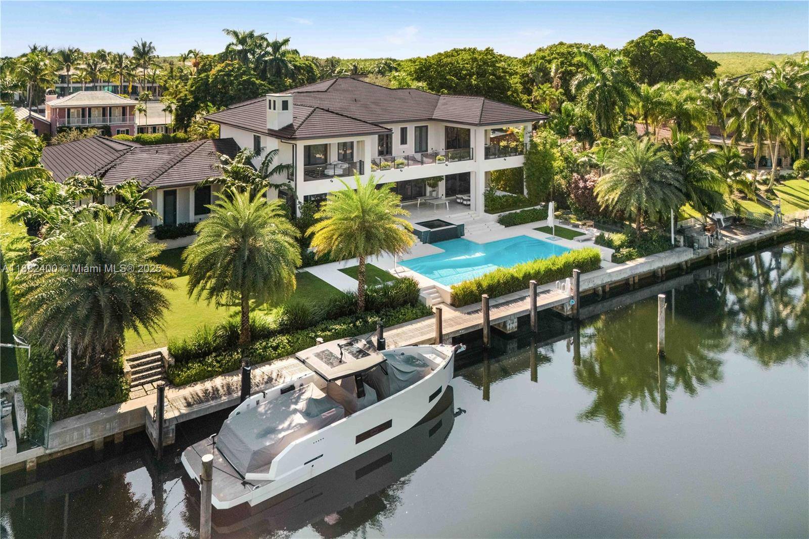 Welcome to a waterfront masterpiece, where contemporary sophistication embraces serene coastal living in prestigious amp ; guard gated Old Cutler Bay.