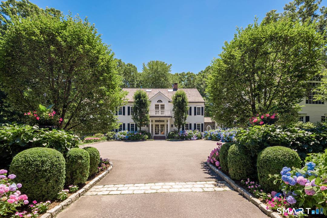 Set on 5 private acres at the end of a coveted cul de sac, this distinctive family compound is minutes to town and top rated schools.