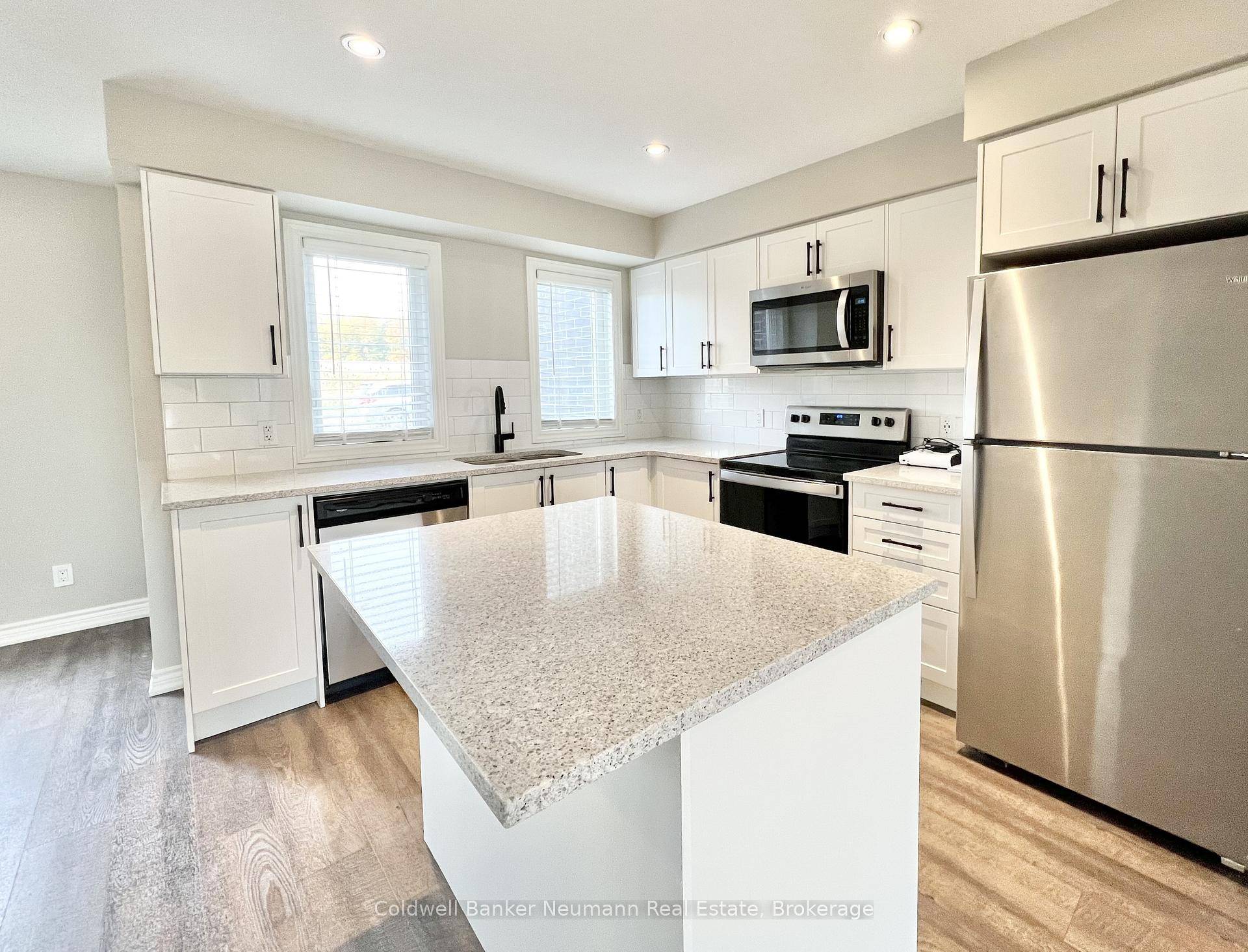 Welcome to 235 Chapel Hill Drive 23, a modern stacked townhome in the desirable Doon South community.