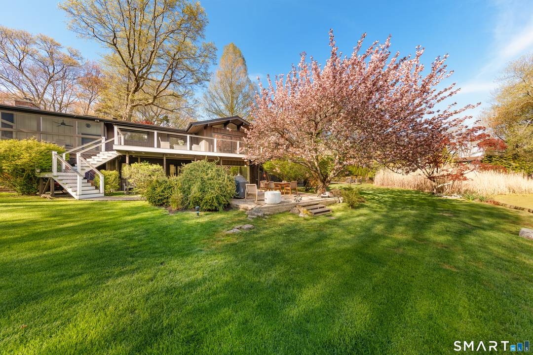 Set in Stamford's coveted north backcountry, this spectacular ranch offers a rare blend of privacy, scale, and serene waterfront living.