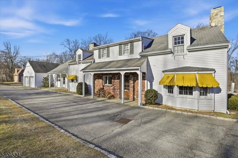 Old meets new in this charming colonial perched behind a semi circular driveway backing to Black River Preserve.