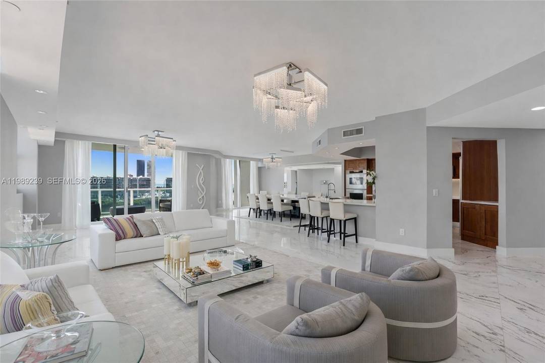 Premium corner residence at Peninsula II in Aventura, offering a true flow through layout with breathtaking east Water views and captivating west facing city and sunset vistas.