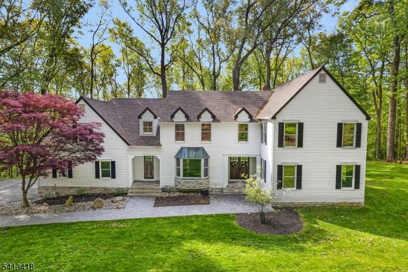 Welcome to this beautifully reimagined 4, 437 square foot Colonial, privately nestled on 4.