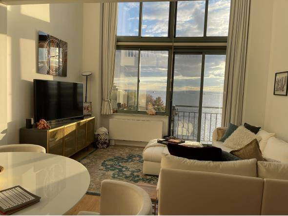Waterfront South facing duplex with spectacular water amp ; status of liberty views, balcony, 18 foot cathedral ceiling.
