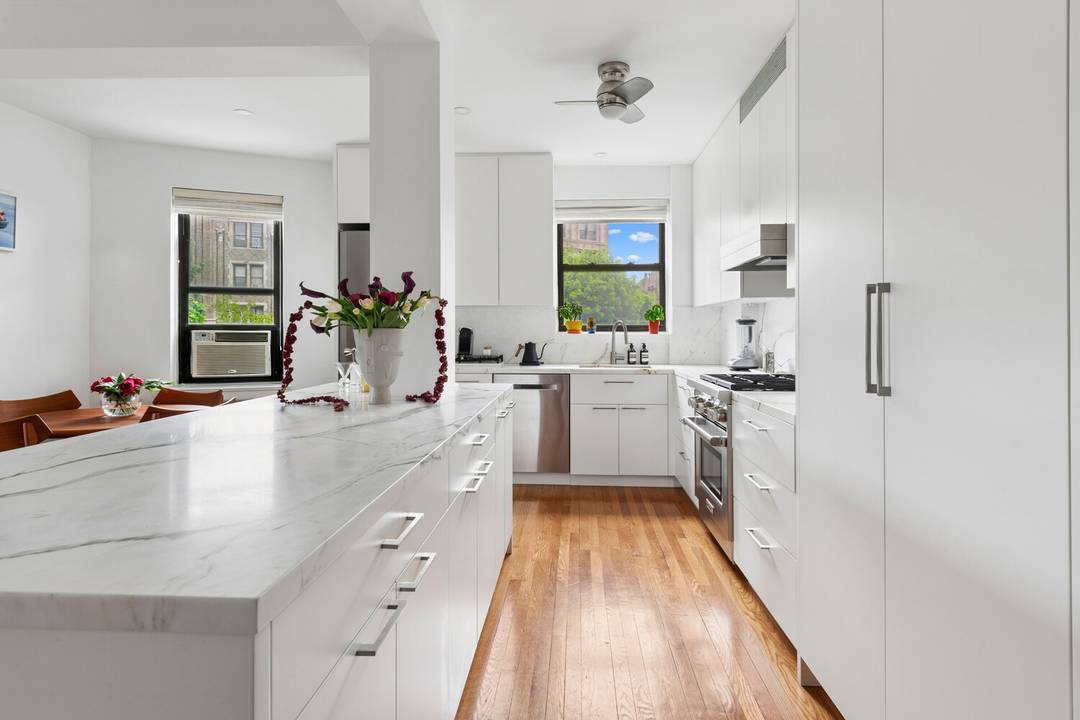 Enter into a spacious gallery foyer, this curated corner home offers high ceilings and abundant northern and eastern light through thirteen 13 windows.