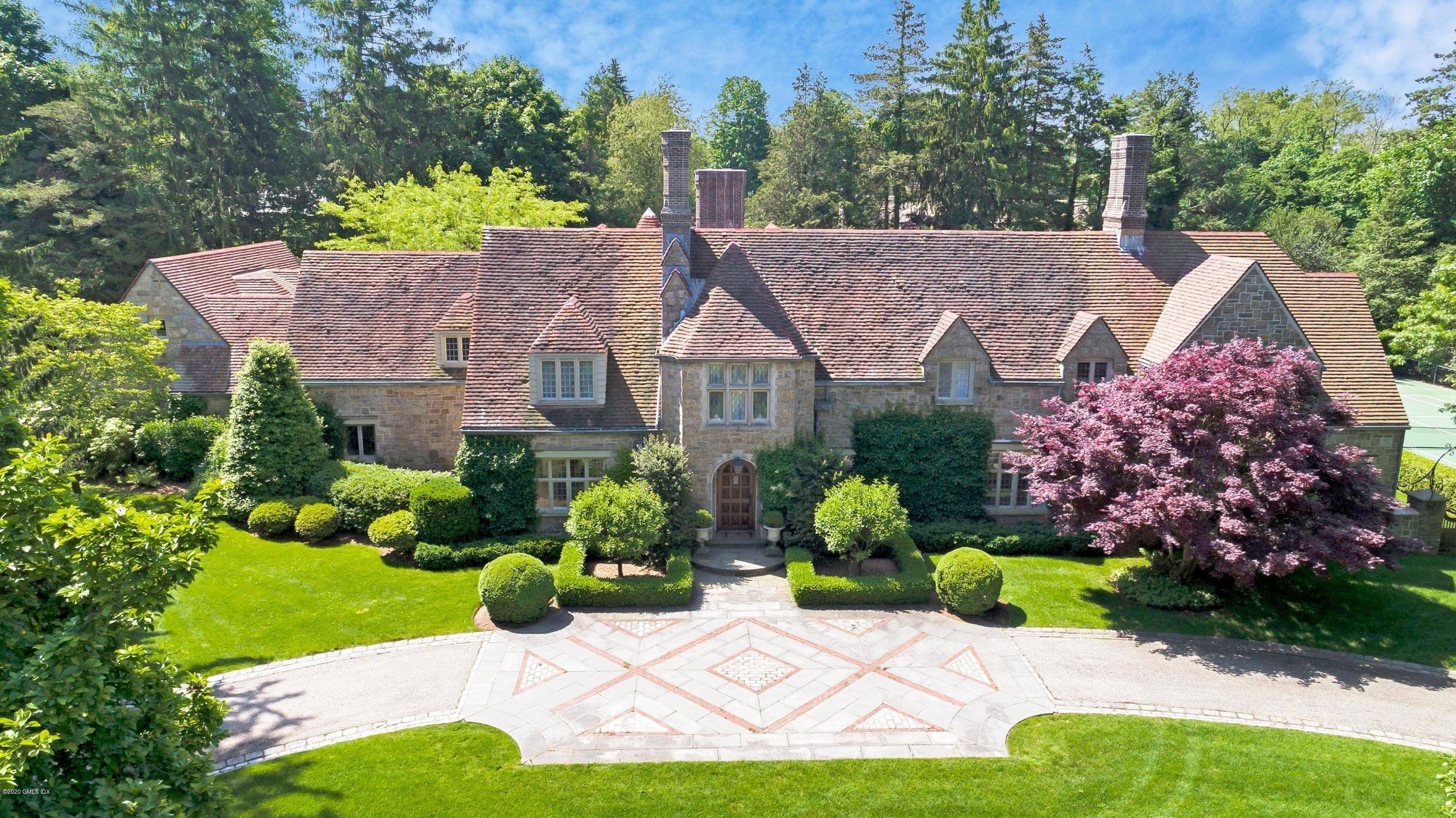 Exceptional Belle Haven peninsula stone English Manor style completely renovated and expanded in 2017 with outstanding quality finishes throughout.