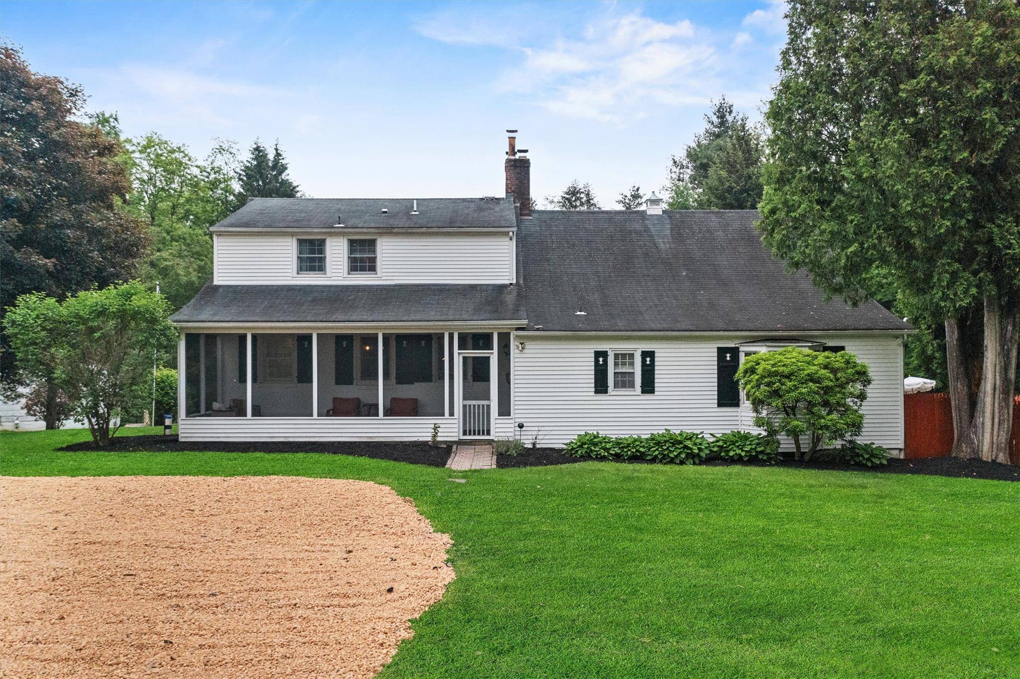 Welcome to 1056 Beekman Road a beautifully updated Cape Cod where timeless charm meets resort style living, set on over 3 acres.