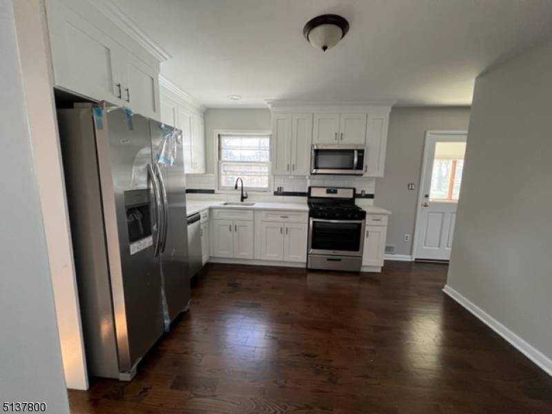 Expanded Cape in the Heights Section of Oakland Features 4 Bedrooms and 2 Full Baths.