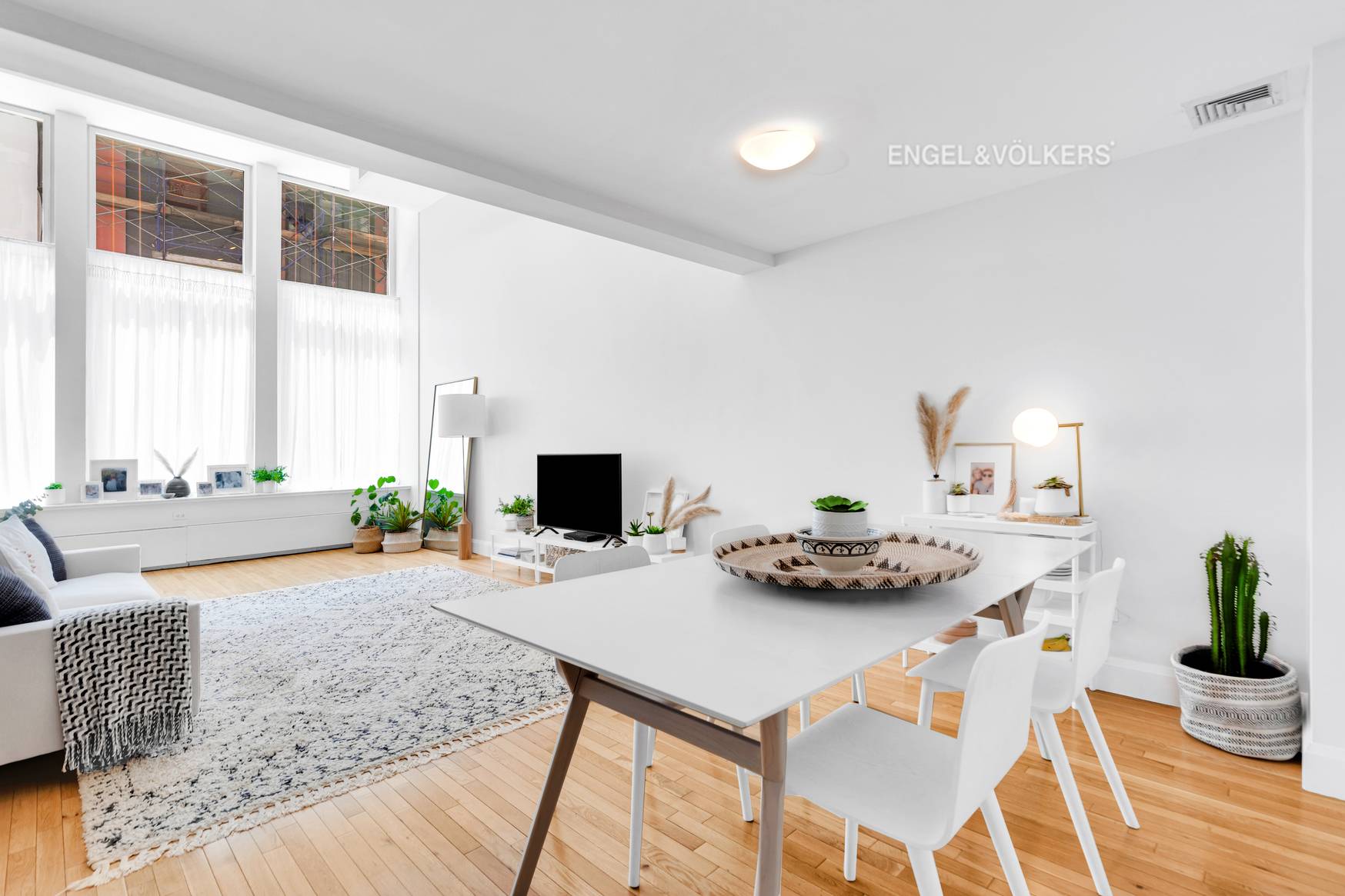 Luxuriously appointed, oversized duplex loft with 16 foot ceilings and a wall of 12 foot tall super quiet industrial tilt and turn windows.