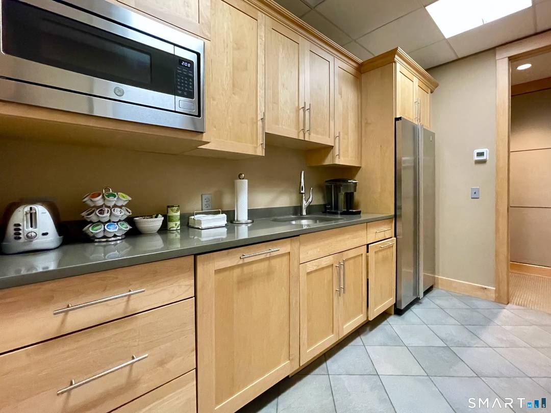 Top tier co working office facility featuring shared kitchen and conference room amenities.