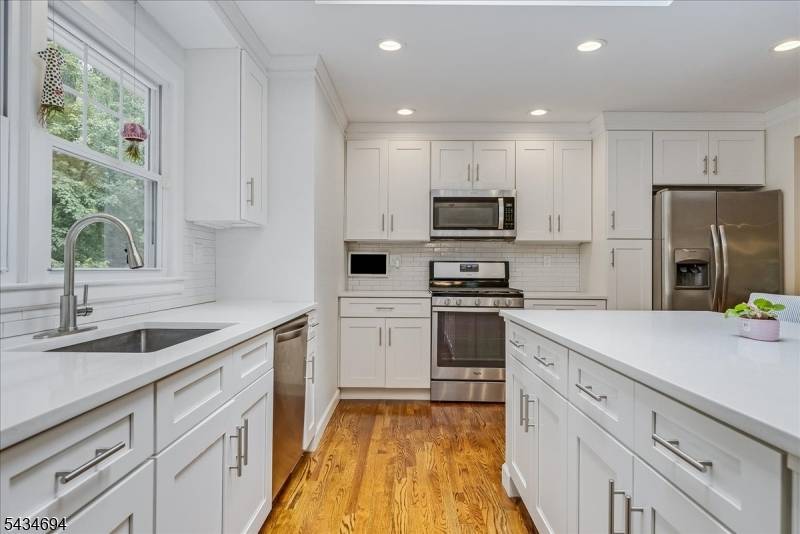 Exceptionally renovated in the heart of Springfield's Baltusrol Top neighborhood, this open, airy, spacious home offers generous living space, thoughtful updates, resting on over half an acre.