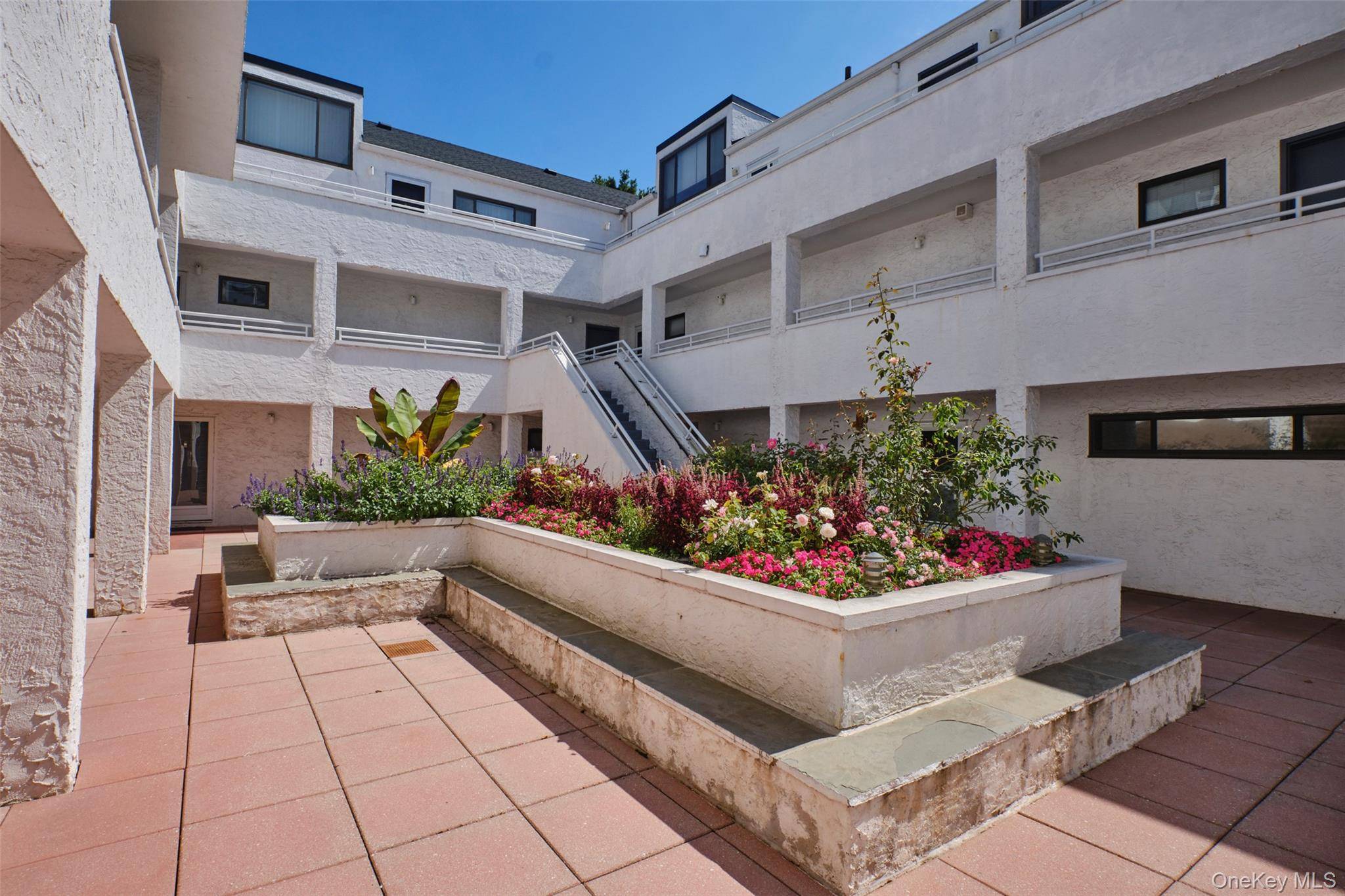 Spacious and sunny 2 bedroom, 2 bath co op in the desirable Canterbury Gardens of Great Neck Plaza.