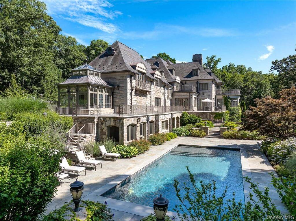This spectacular limestone French Manor estate sits on 10 acres on Converse Lake with 100' of lakefront in exclusive Conyers Farm, a guard gated community with private security.