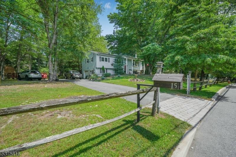 Welcome to 15 Brookwood Drive, nestled in one of Mahwah's most desirable residential enclaves, surrounded by custom homes valued at 1.