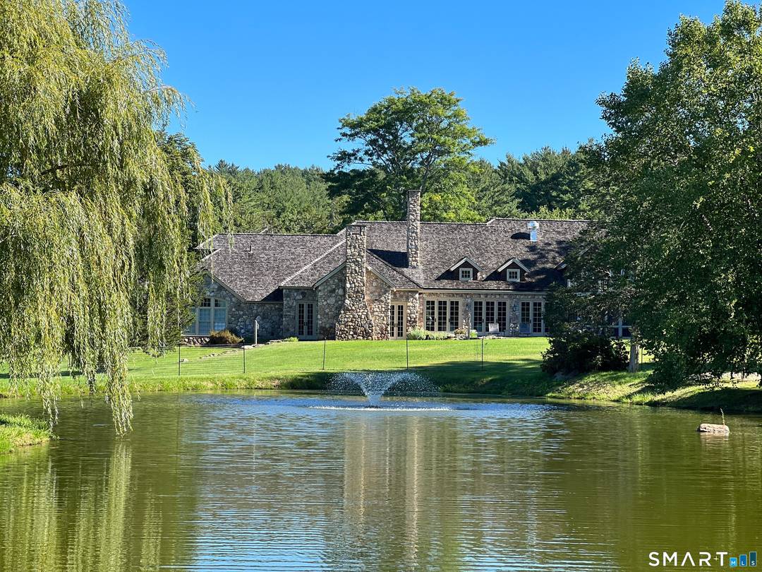 Welcome to this extraordinary stone and shingle country estate, nestled on 70 acres of private retreat.