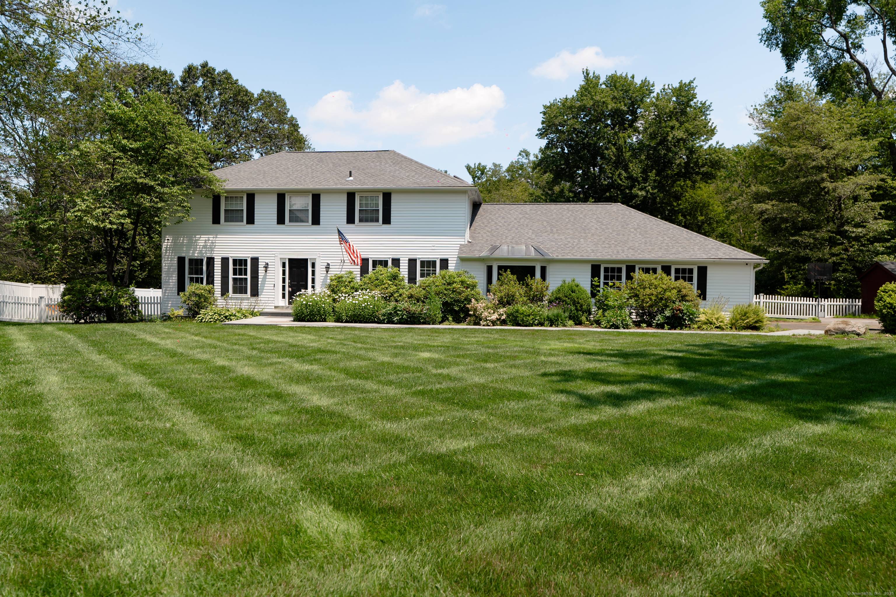 Welcome to this stately charming Colonial situated on a private, park like 1.