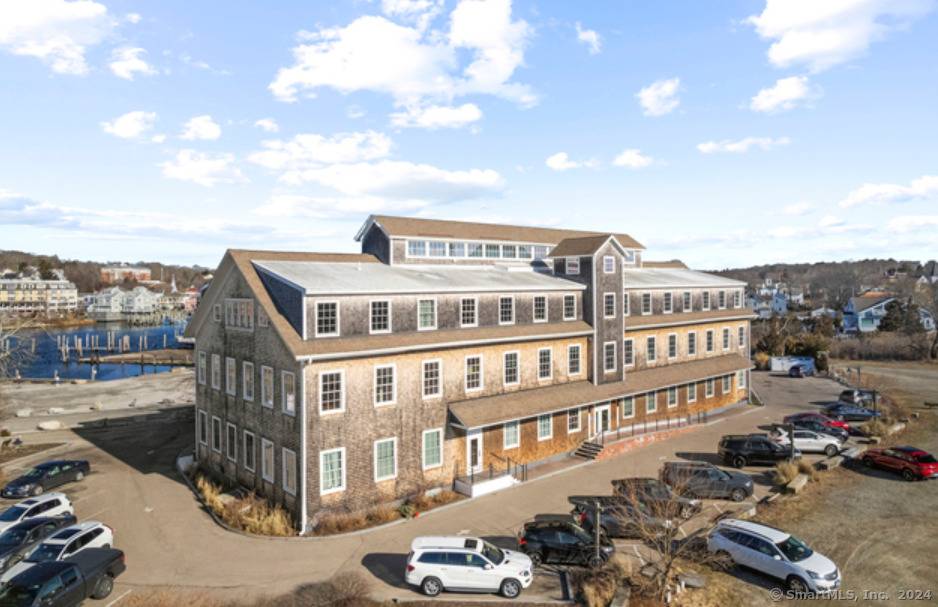 Direct water views of the Mystic River from this penthouse unit at the iconic Spool Mill.