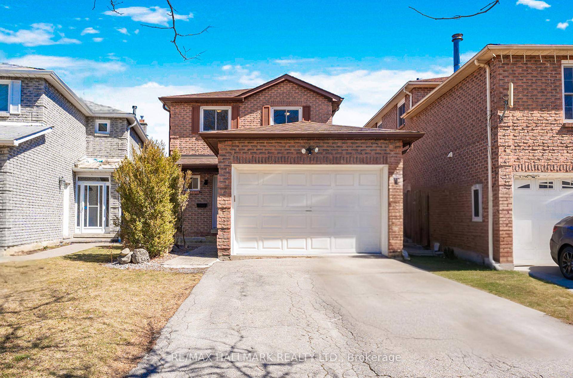Detached 2 storey brick home with an attached garage and double car driveway.